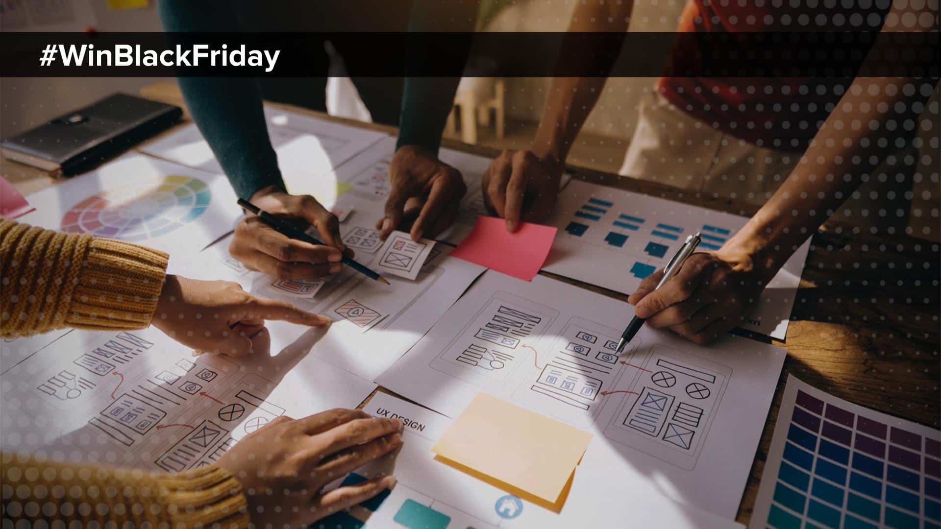 Black Friday Creative Planning in 5 Easy Steps Blog Image _ 3 people around a conference table with brainstorming documents in front of them