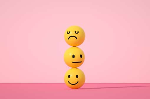 3d rendering of emoji with smiley, sad and neutral face on pink color background.